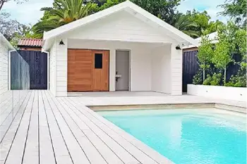 home-extensions An outdoor area with a pool and white pool house with wood accents